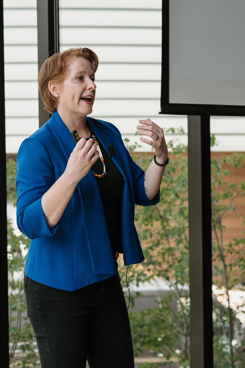 A keynote speaker presents to the symposium audience