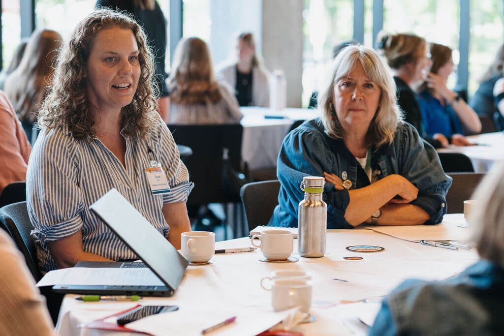 Attendees in discussion at a round table