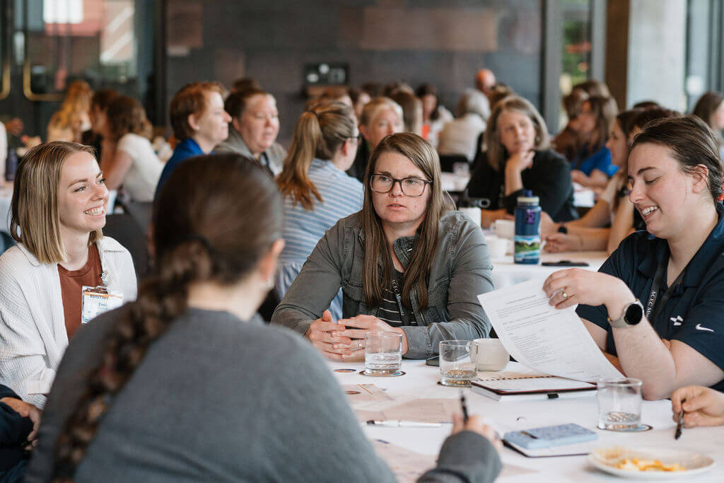 Attendees work through a table exercise together