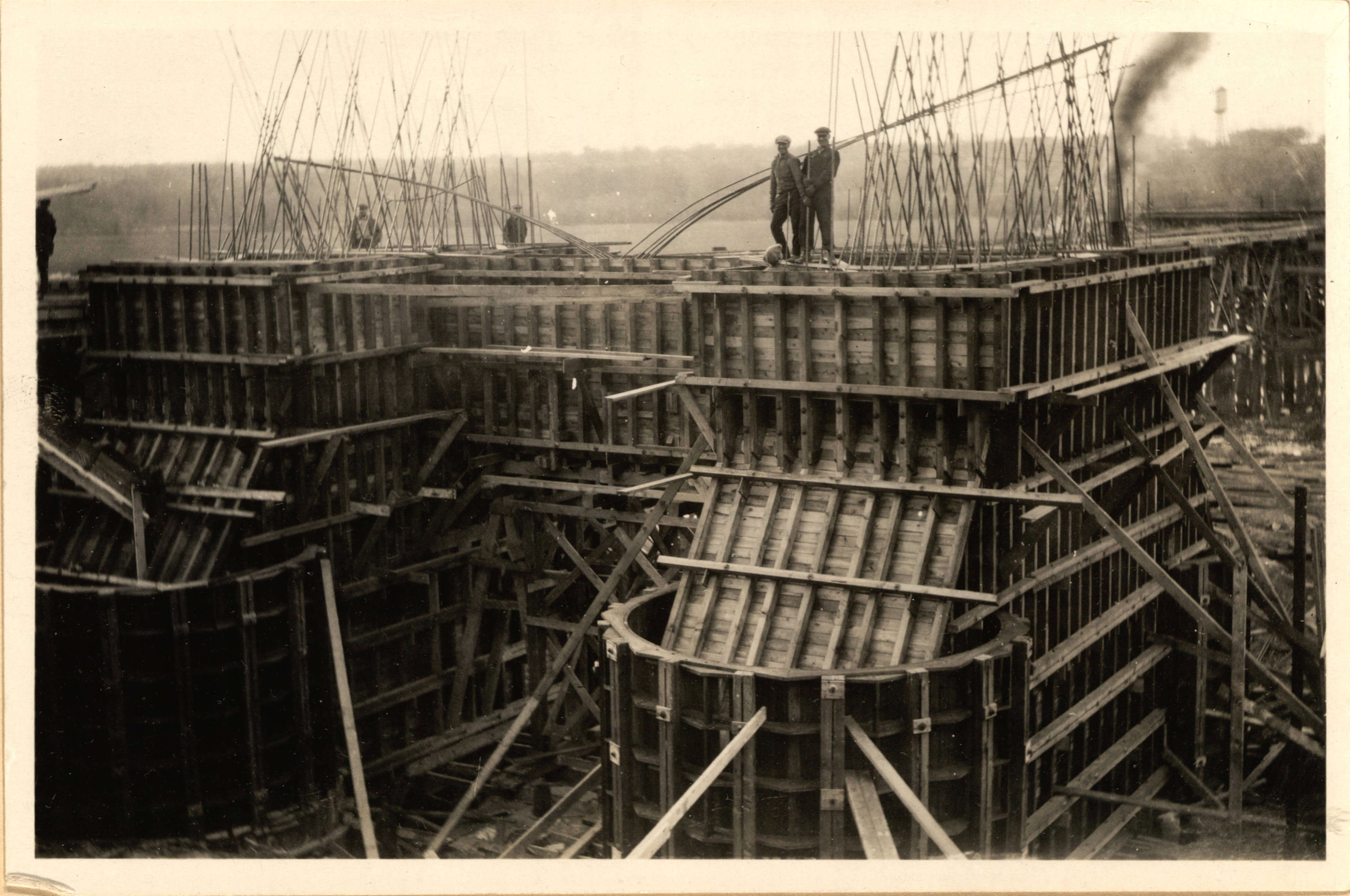 The Mendota Bridge under construction in 1925, a concrete pier with wooden scaffolding and steel rebar