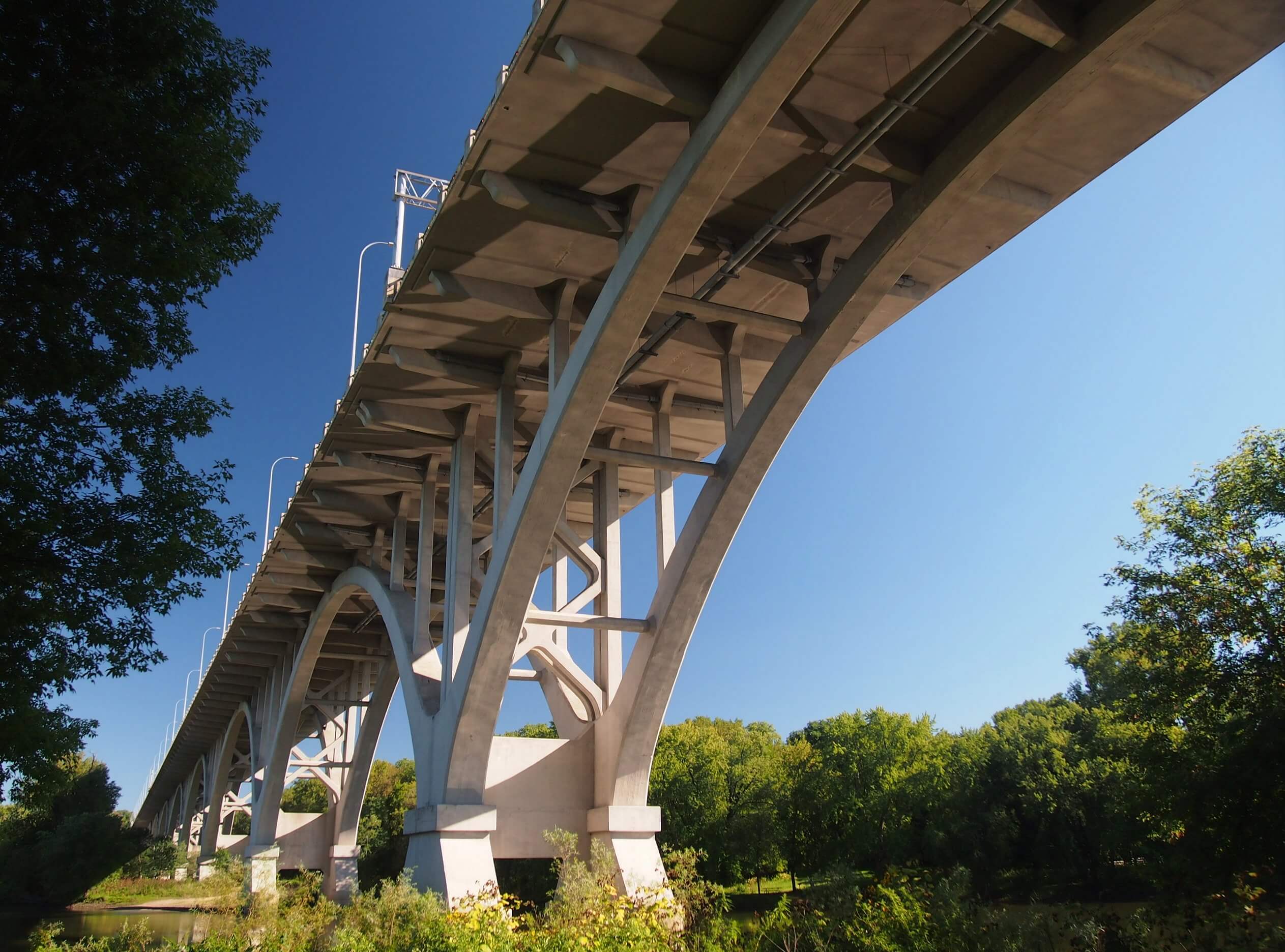 View of the Mendota Bridge's concrete arches from below