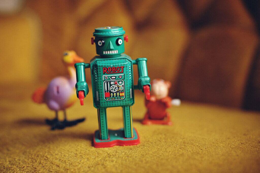 Robot toy with a couple toys blurred in the background