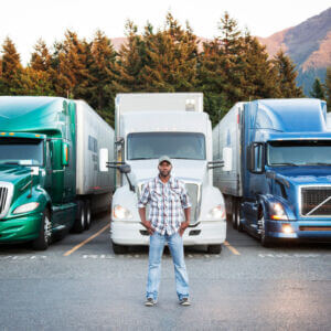 man in front of trucks