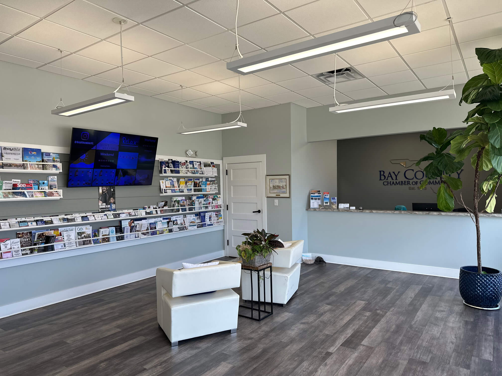Photo showing the lobby of the Chamber, including a high-resolution display, member marketing materials, and reception area.