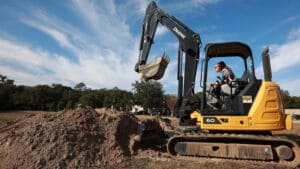 Trainee operating an excavator during transportation workforce training