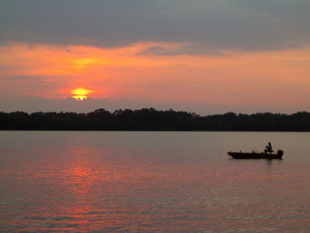 Boater fishing on the water at sunset in Springfield, Florida