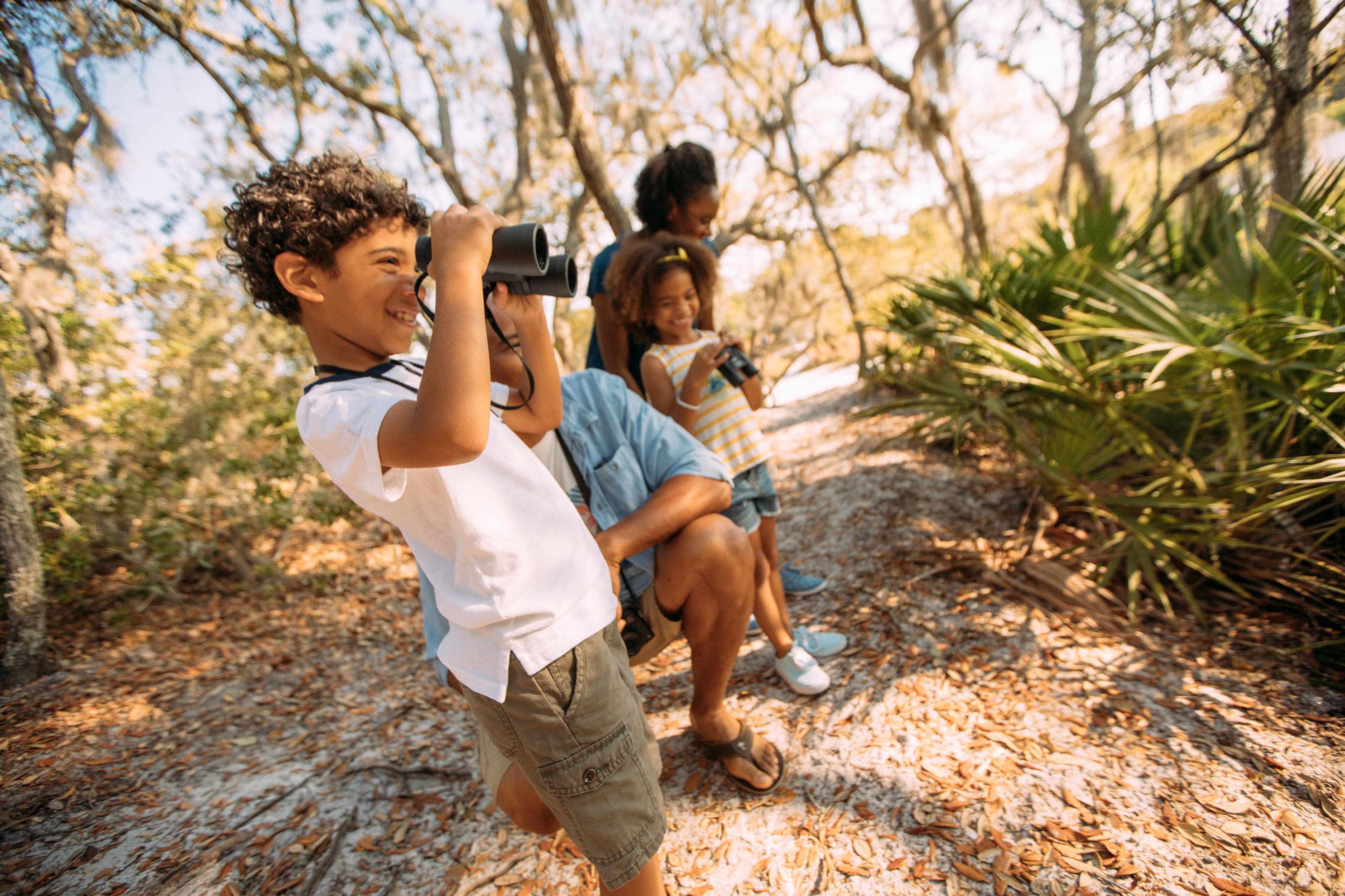 Family exploring a wooded nature trail in Bay County, Florida