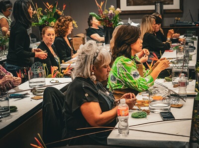 Hands-on workshop attendees enjoy creating beautiful floral designs