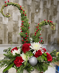 Grinch tree made of evergreens, red roses, red carnations, white spider mums, red berries and more.
