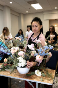 floral design student creates a beautiful arrangement at the Texas Floral Expo
