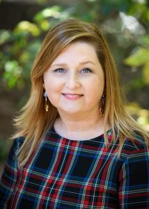 Stacey Brewer Stacey is smiling and wearing a plaid shirt