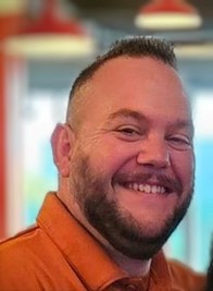 Jonathan Sparks Headshot Jonathan is wearing a burnt orange polo shirt