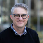 Steve Dombrowski Steve has short hair and is wearing glasses and a dark sweater