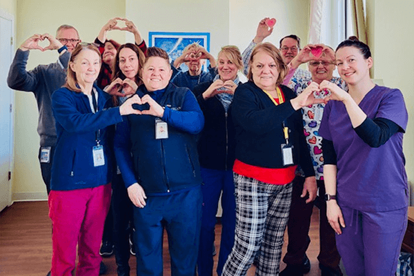 group of pleople making hearts with their hands