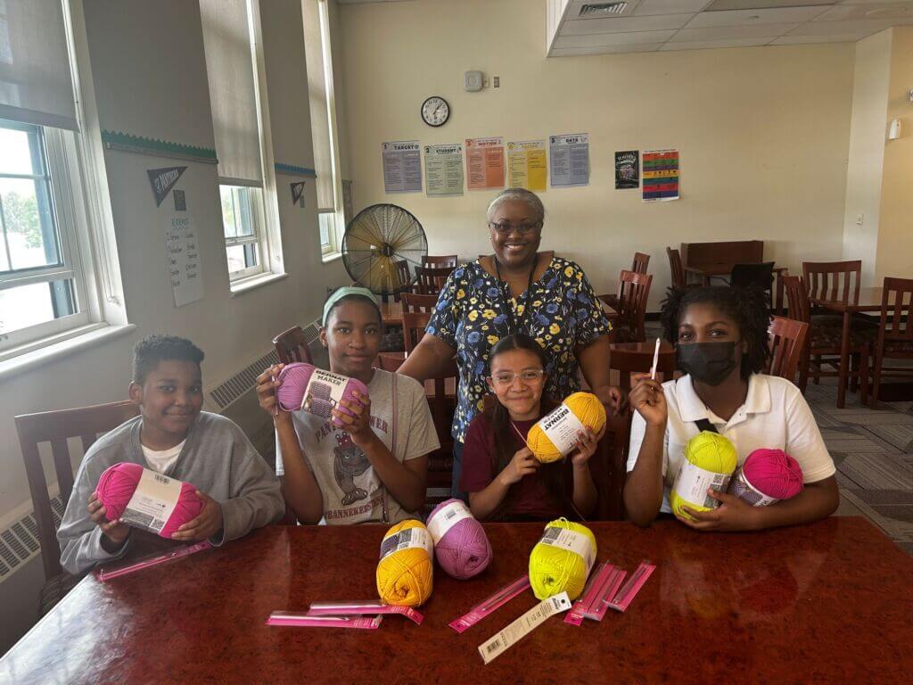 students with crochet supplies