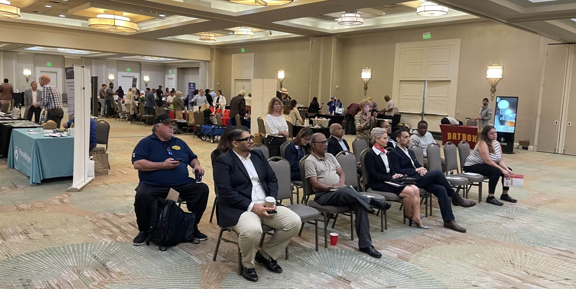 Photo of 2025 business expo audience watching panel discussion.