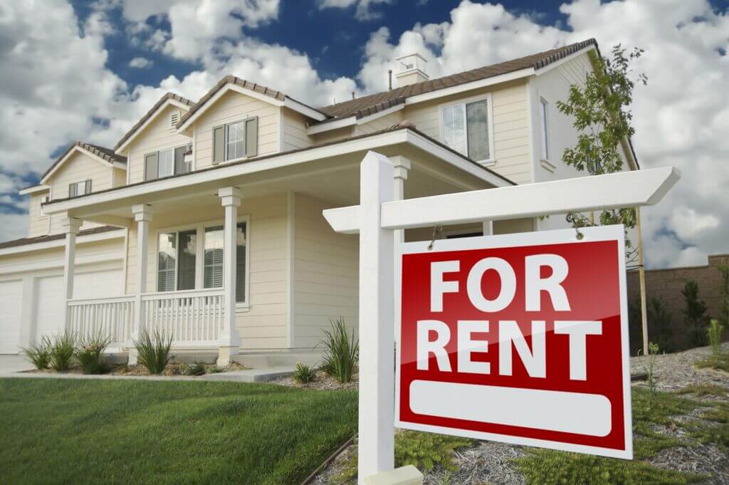 home exterior with a for rent sign in front