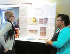 PosterSession7 Photo of two people discussing a poster