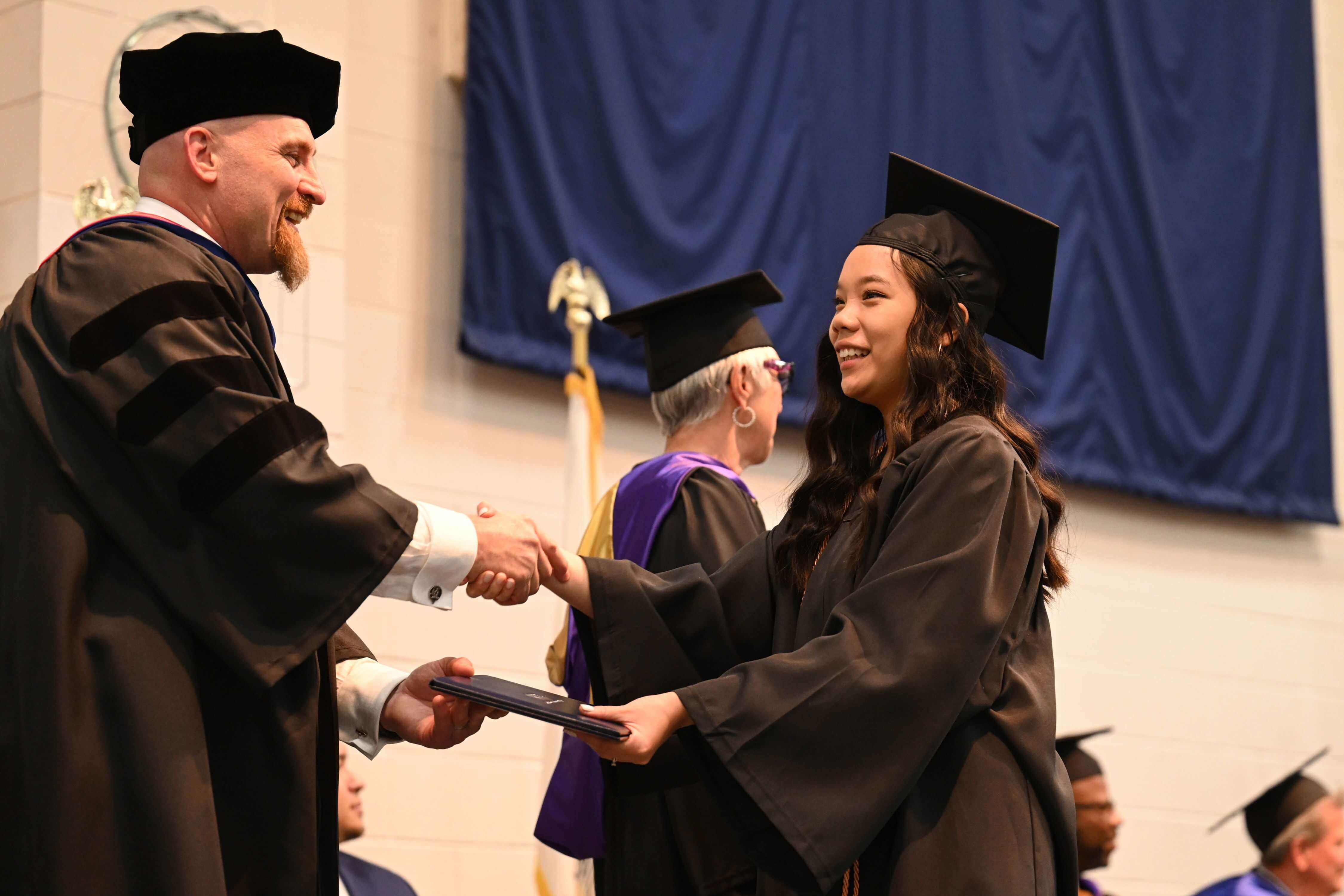 Dr. Michael Boyd congratulates graduate Hannah Bowers