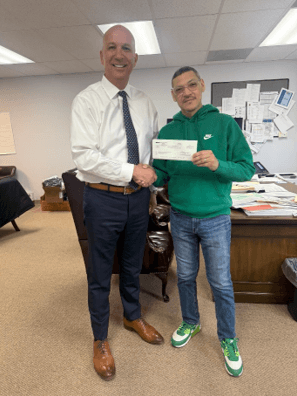 (left to right: Phillips Chevrolet General Manager Mike Maheras; Executive Director of Kankakee County Community Services, Inc Anibal Vega.)