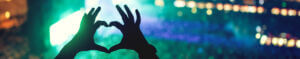 hands making heart shape at a concert