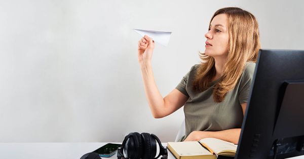 person throwing paper airplane