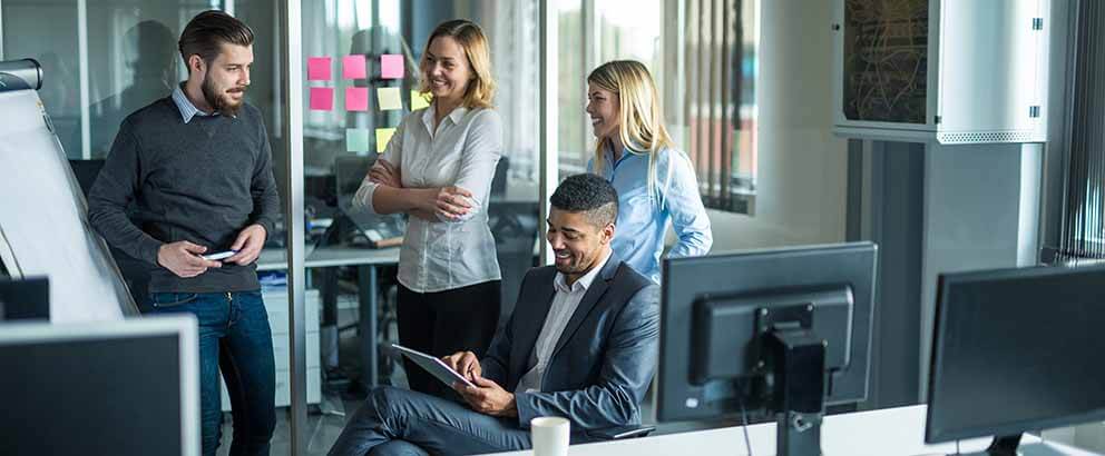 Happy team of coworkers working together in an office.