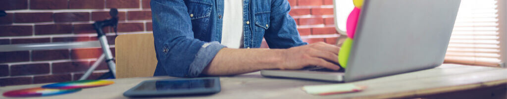 man typing on laptop