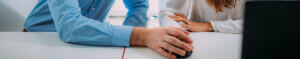 man and woman holding hands on computer mouse