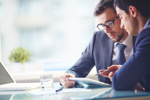 BusinessmenLookingAtAPaper_sml BusinessmenLookingAtAPaper_sml