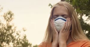 Girl wearing Facemask in Wildfire