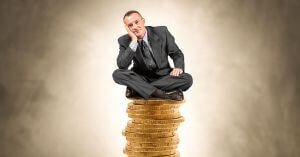 Man Sitting On Top Of Money
