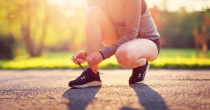 Woman Runner Tying Shoes