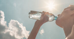 Woman Drinking Water on a Hot Day