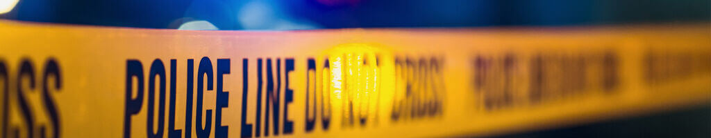 Police tape over blurry background