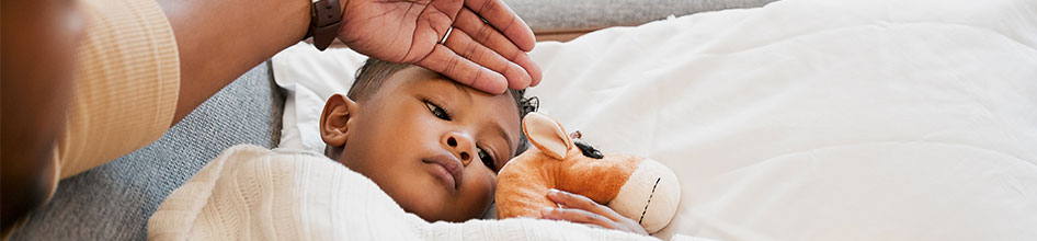 dad checking kid's temperature
