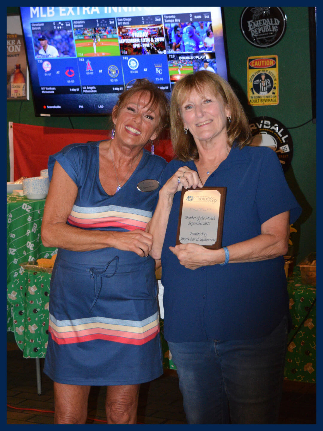 Photo of member of the month winner with plaque and staff member