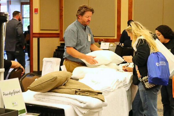Savings-PG man talking with woman about pillow