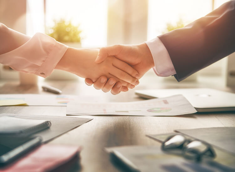Photo of two people shaking hands.