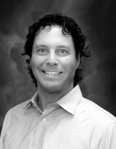 Kyle Volh - headshot with background BW