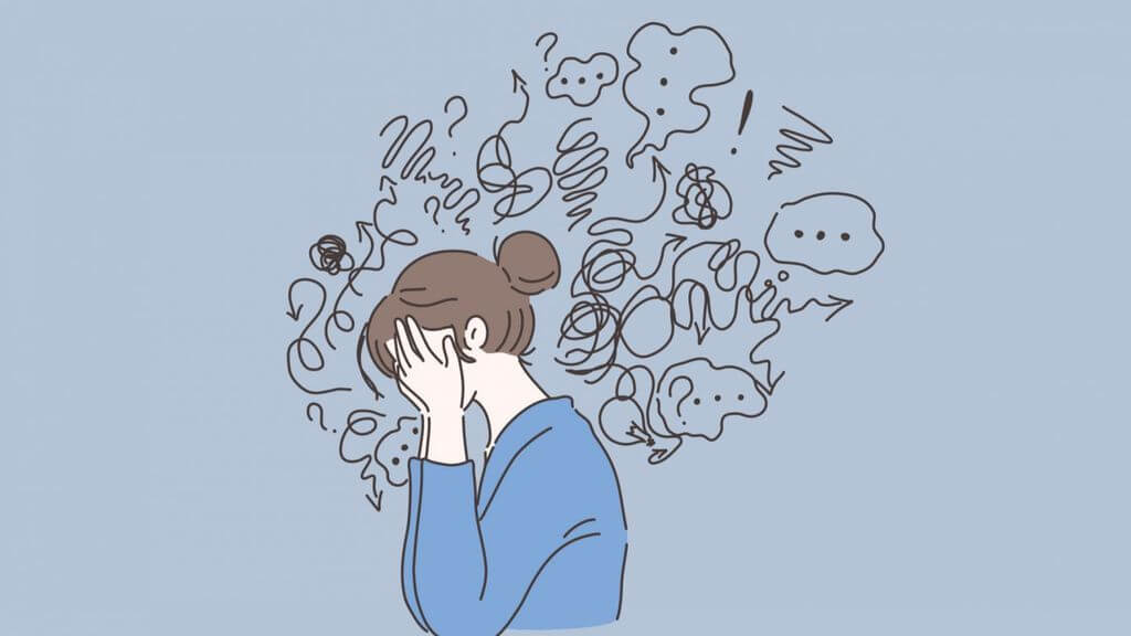 woman feeling overwhelmed, head in hands 
