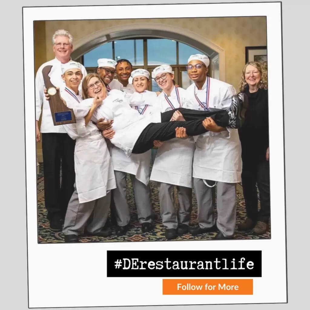 chefs holding another chef that is holding trophy