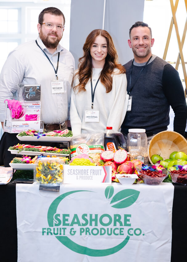 3 people in booth with food