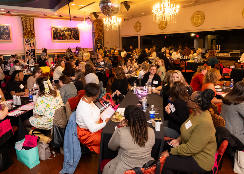 people seated around tables at event