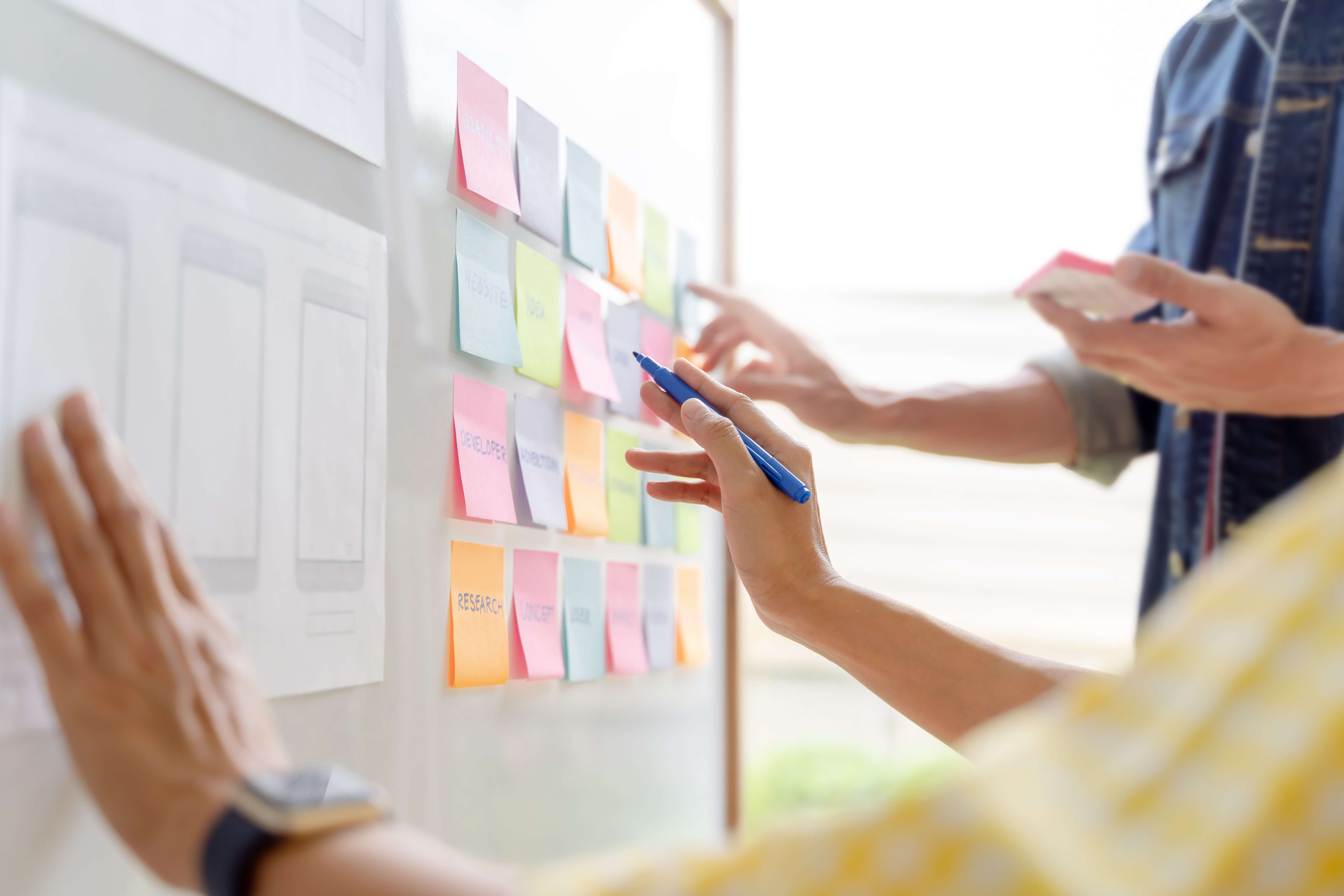 Application Web designer working together with UX and UI in studio office.