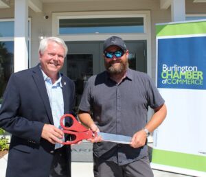 group photo holding ribbon cutting scissors