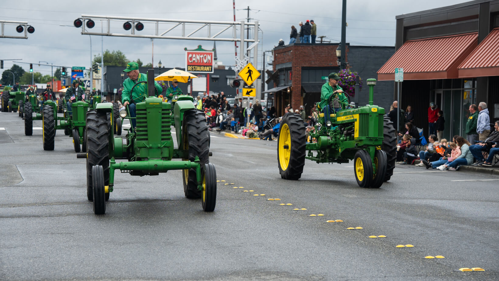 John Deere tractors participating in the Berry Dairy Days Grand Parade on Fairhaven Avenue in Burlington, Washington