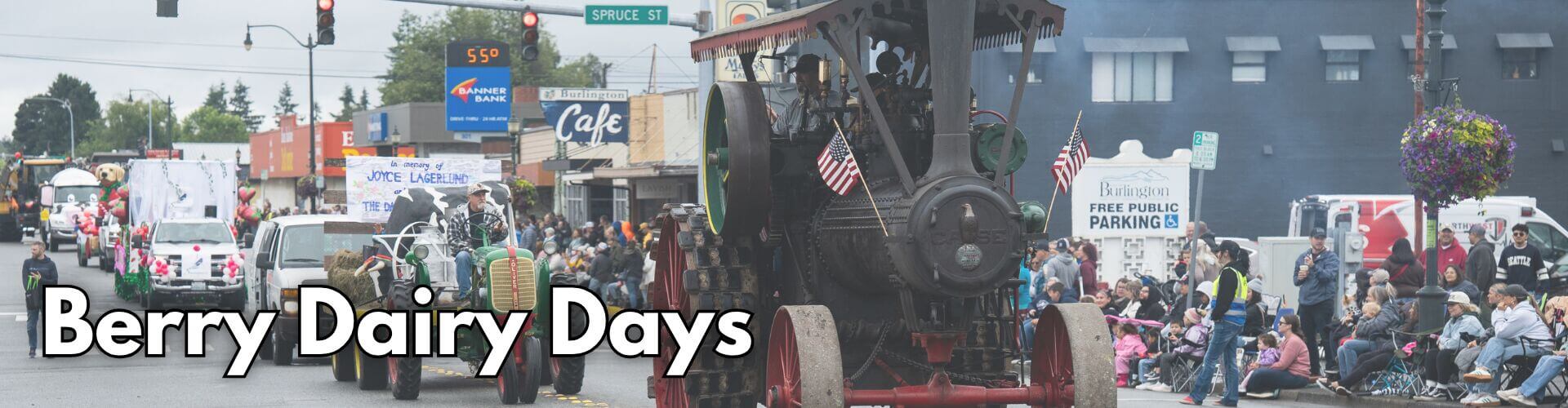 Train leading the Berry Dairy Days Grand Parade in Historic Downtown Burlington, Washington, with colorful floats and community participants celebrating one of Skagit Valley's longest-running festivals.