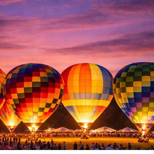 Hot air balloons glowing at night during Berry Dairy Days in Burlington WA