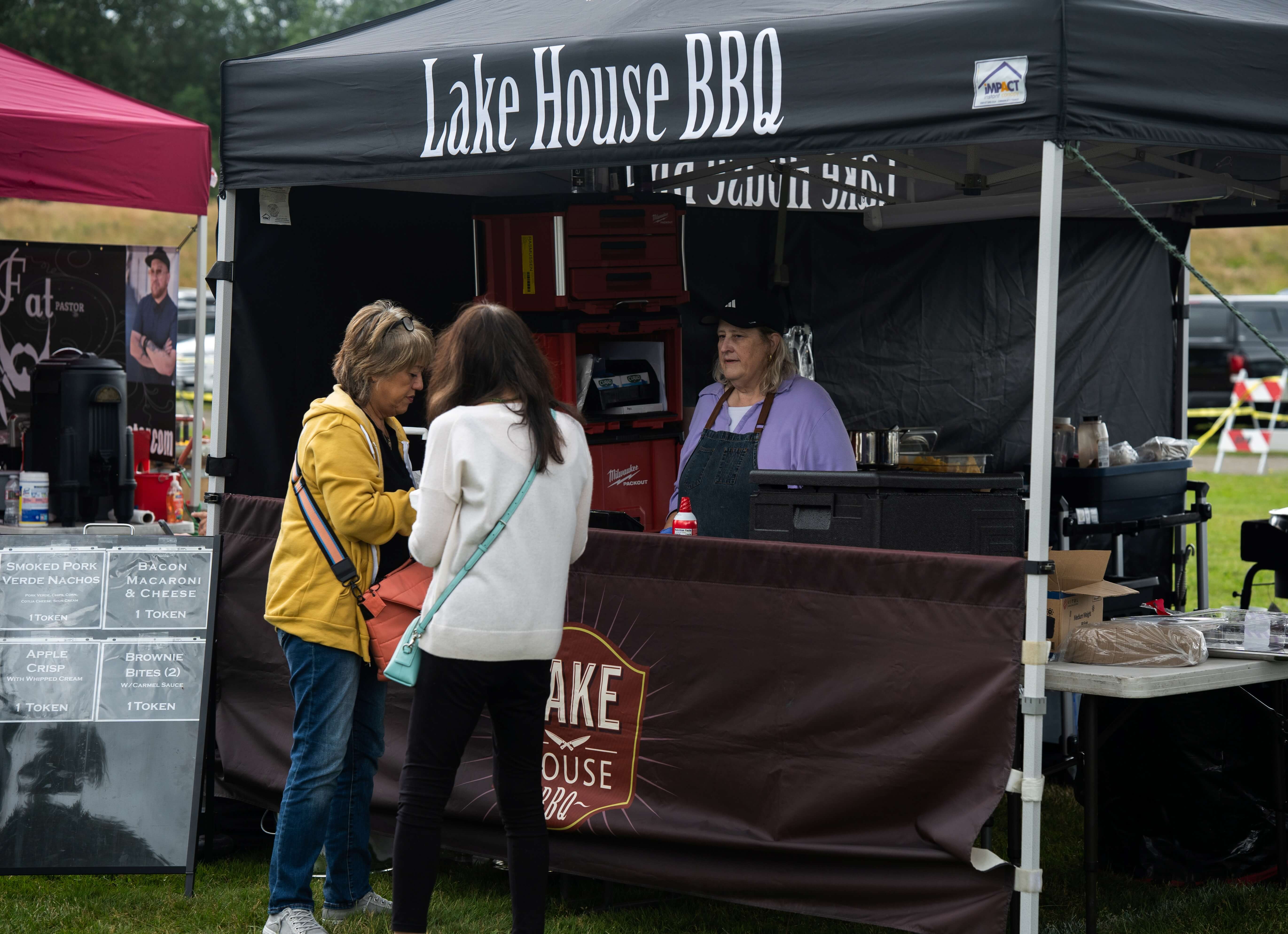 Festival attendees receive BBQ tasting samples from a competing team during the Berry Dairy Days Smoke & Grill Competition.